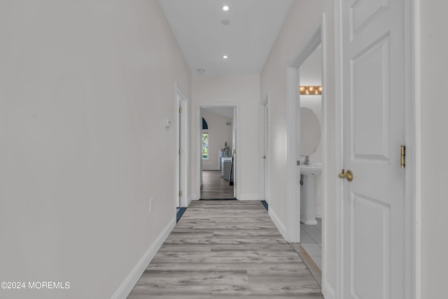 hallway with light hardwood / wood-style flooring