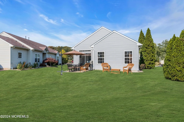 back of property with a patio area and a lawn