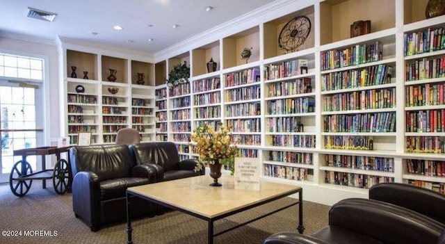 living area featuring crown molding and carpet floors