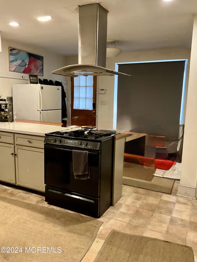 912 W State St, Trenton, NJ 08618 - kitchen featuring black gas range, freestanding refrigerator, island range hood, light countertops, and recessed lighting