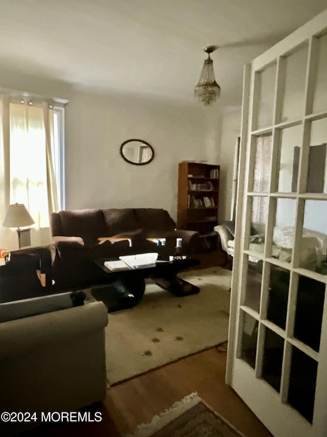 living room with wood-type flooring and a notable chandelier