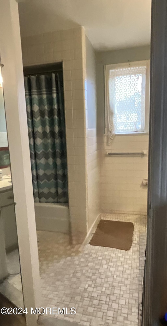 bathroom with tile walls