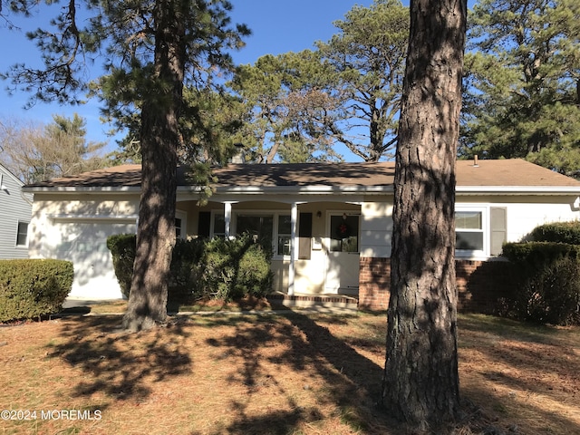 ranch-style house with covered porch and a garage