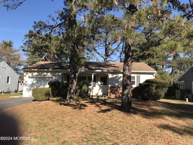 view of front of property with a garage and a front yard