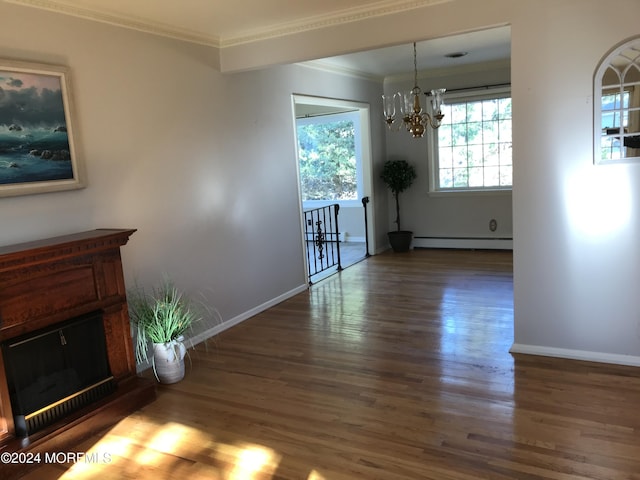 unfurnished dining area with baseboard heating, an inviting chandelier, dark hardwood / wood-style floors, and ornamental molding