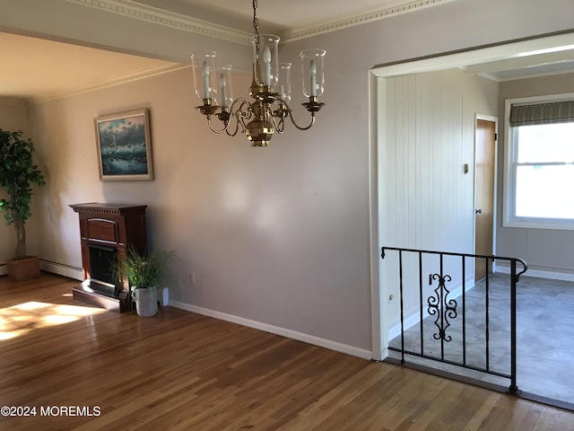 unfurnished dining area featuring dark hardwood / wood-style floors, crown molding, and a notable chandelier