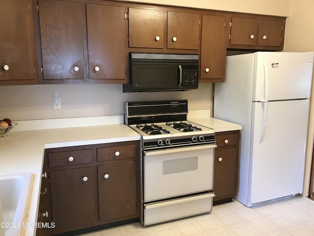 kitchen featuring sink and white appliances