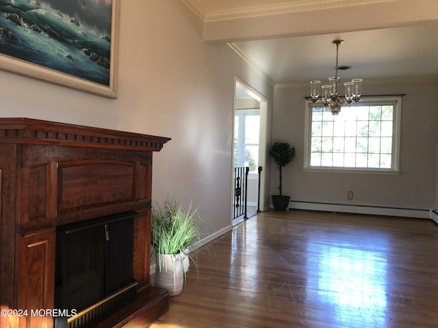 interior space with dark hardwood / wood-style floors, ornamental molding, baseboard heating, and a chandelier