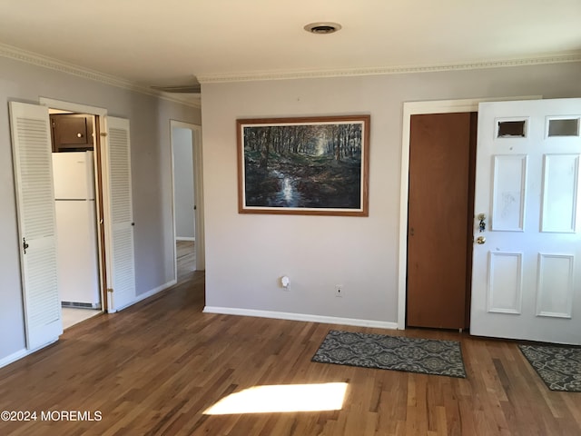 entrance foyer with crown molding and dark hardwood / wood-style floors