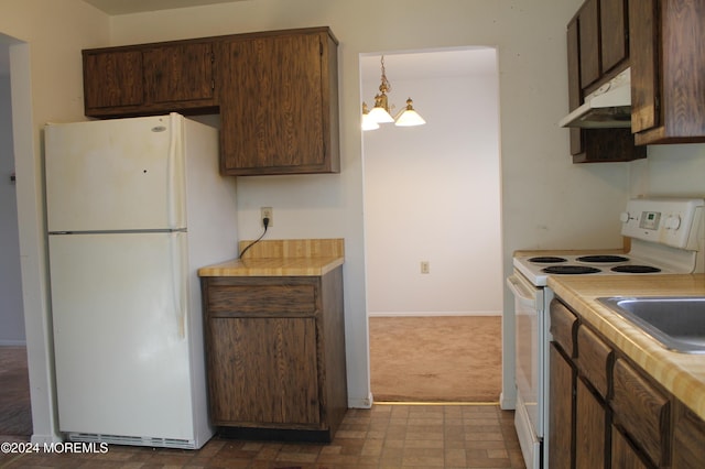 kitchen with pendant lighting, dark carpet, white appliances, an inviting chandelier, and dark brown cabinets