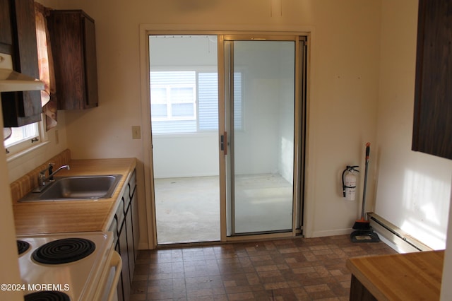 kitchen with white range with electric stovetop, baseboard heating, and sink