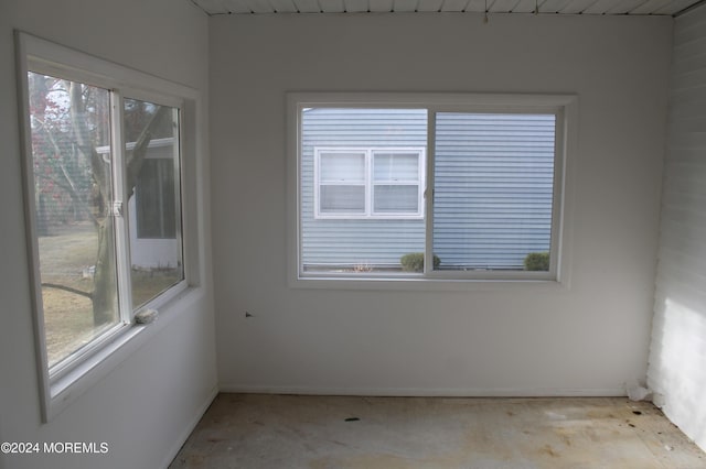 spare room featuring wood ceiling and a wealth of natural light