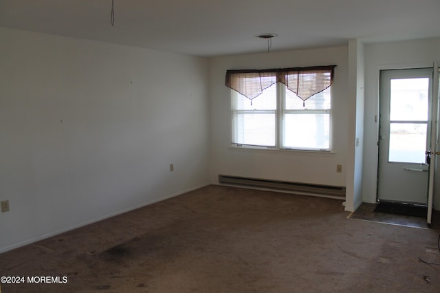 unfurnished dining area with plenty of natural light, dark carpet, and a baseboard heating unit