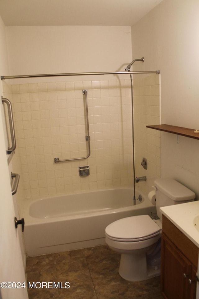 full bathroom featuring tile patterned flooring, vanity, tiled shower / bath combo, and toilet