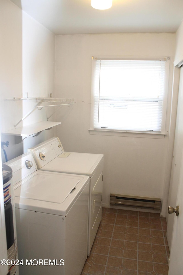 laundry area featuring washing machine and dryer, dark tile patterned flooring, and baseboard heating