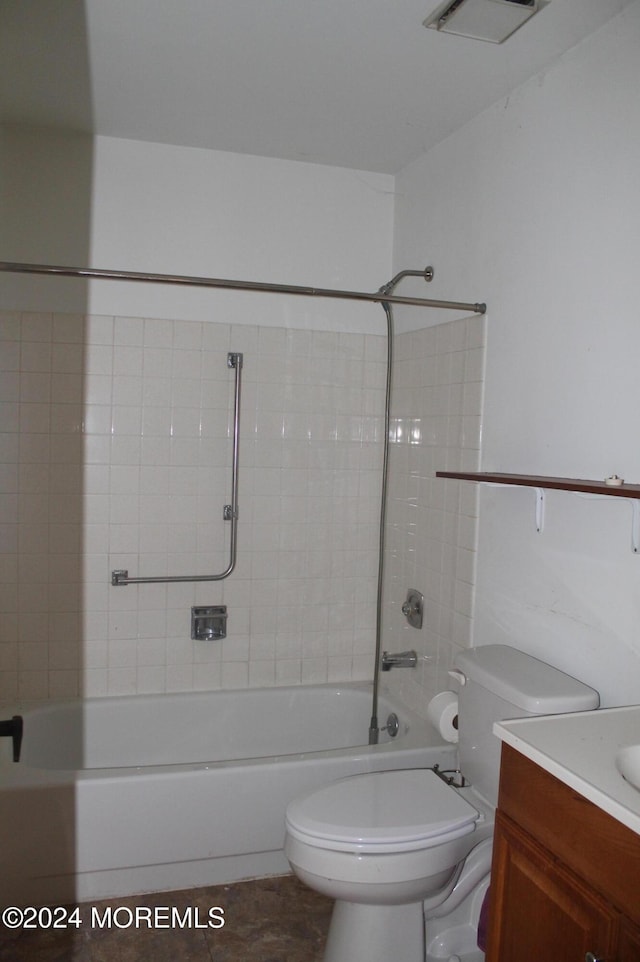 full bathroom with toilet, tile patterned flooring, vanity, and tiled shower / bath