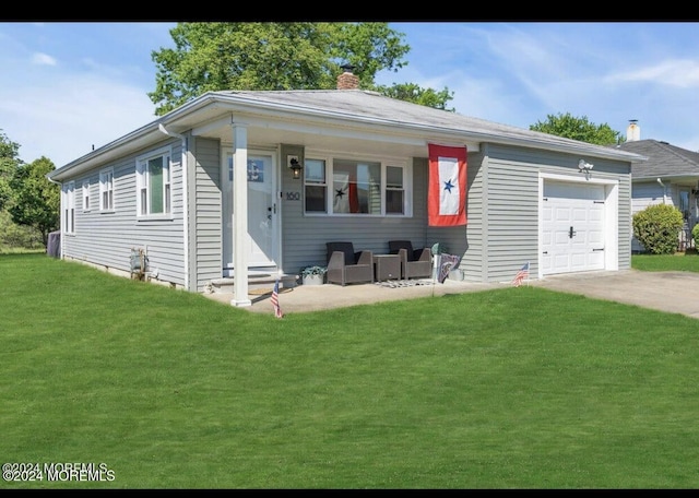 view of front of property with outdoor lounge area, a front lawn, and a garage