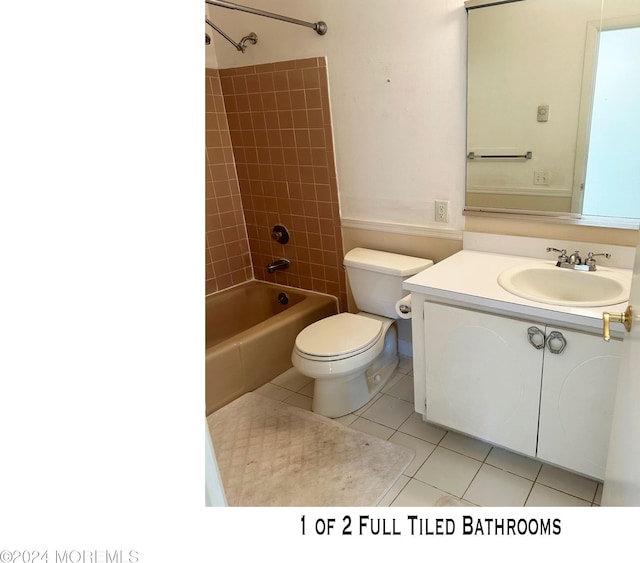 full bathroom featuring toilet, vanity, tile patterned floors, and tiled shower / bath