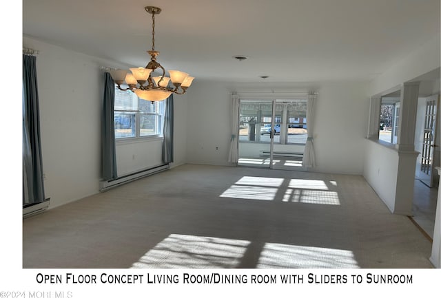 empty room with light colored carpet, a baseboard heating unit, and a notable chandelier