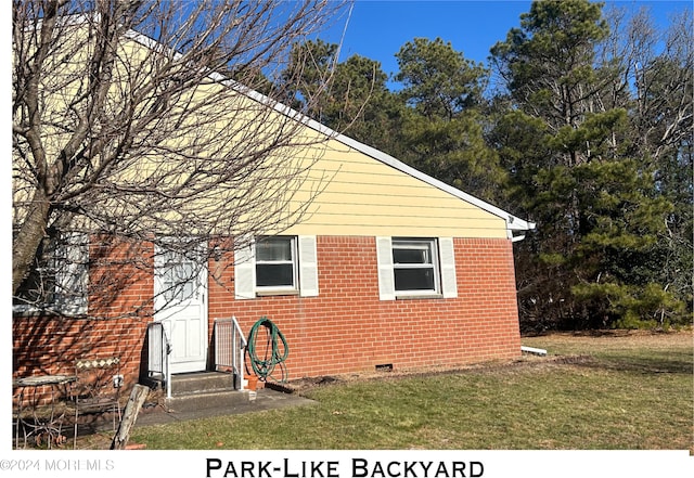 view of side of property with a lawn