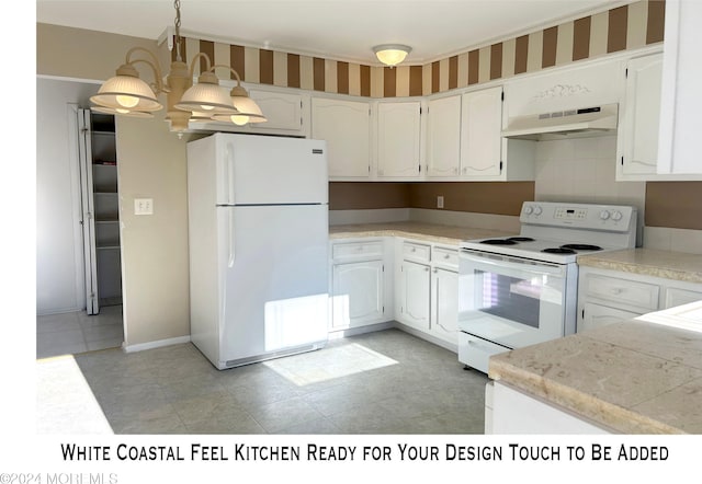 kitchen featuring white cabinets, a notable chandelier, and white appliances