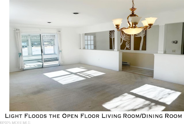 spare room featuring baseboard heating, carpet, and a chandelier