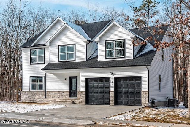 view of front of house featuring a garage and cooling unit