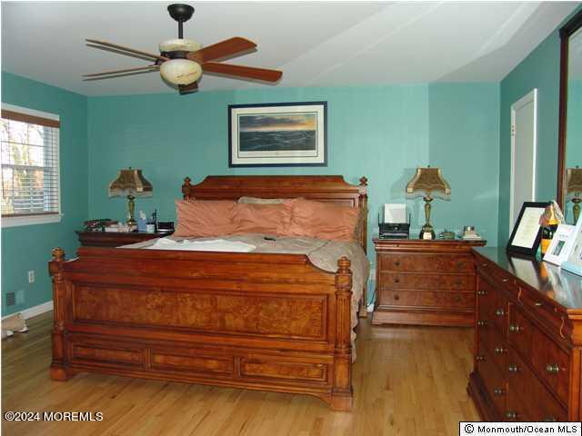 bedroom with ceiling fan and light hardwood / wood-style floors