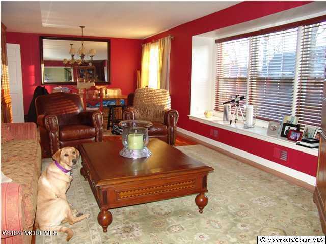 living room with a healthy amount of sunlight and a notable chandelier