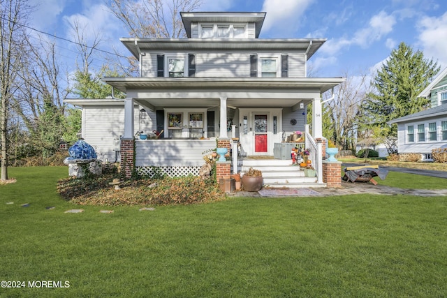 view of front of house featuring covered porch and a front yard