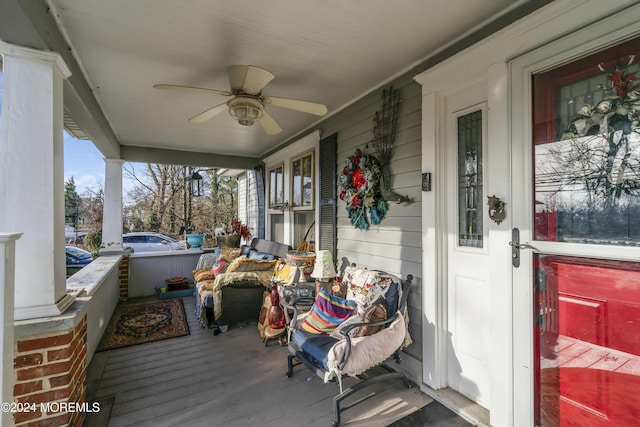 wooden deck with a porch and ceiling fan