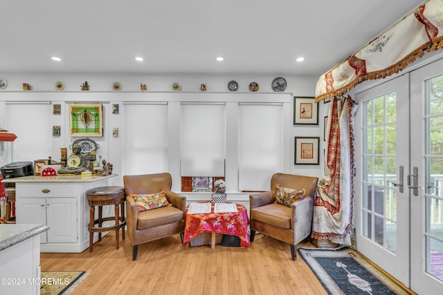 living area featuring light wood-type flooring and french doors