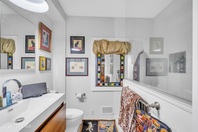 bathroom with vanity and toilet