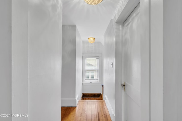 hall with light hardwood / wood-style floors