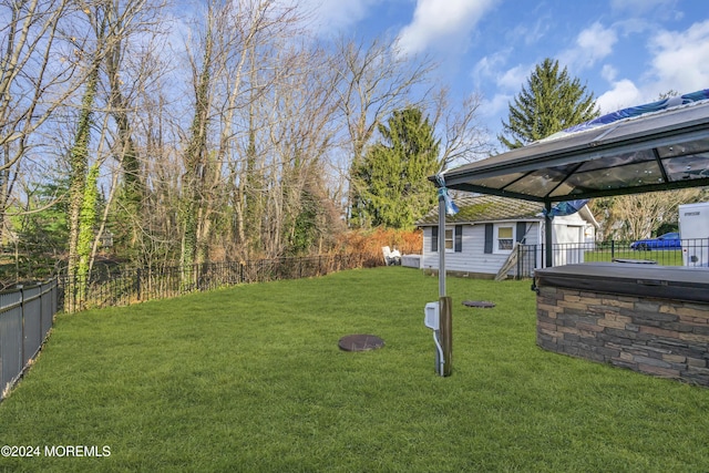 view of yard featuring a gazebo and a hot tub