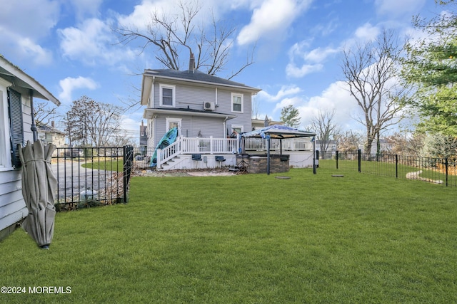 back of property with a gazebo and a yard