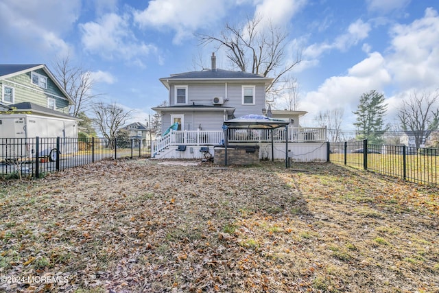 back of house with a gazebo and a wooden deck