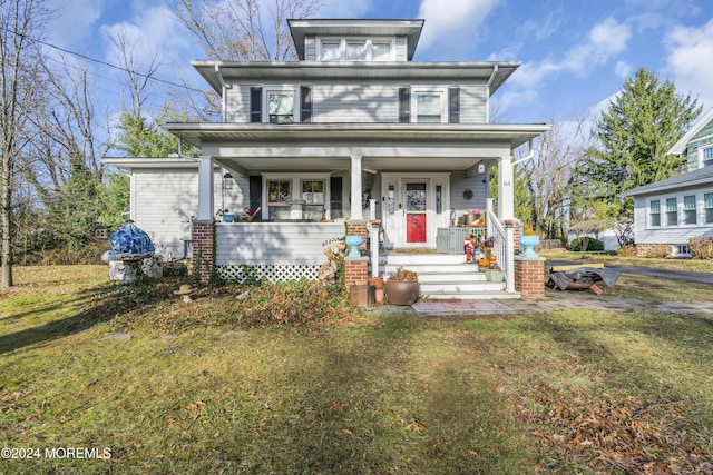 view of front of home with covered porch and a front yard