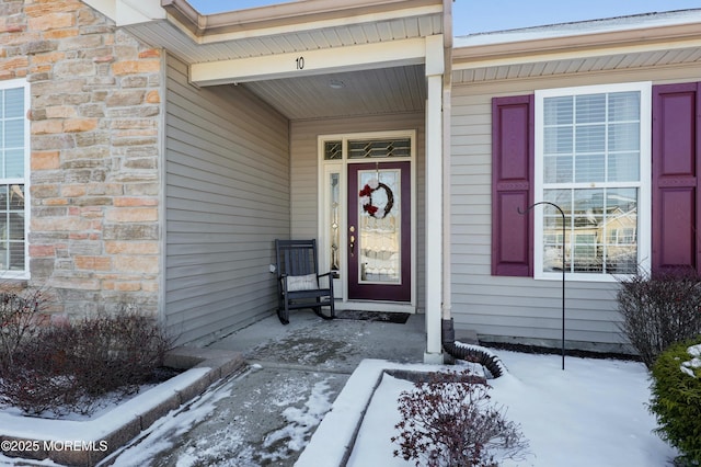 view of snow covered property entrance