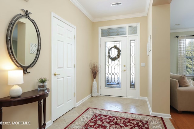 foyer featuring light tile patterned floors and crown molding