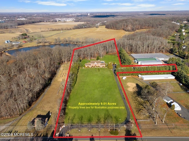 birds eye view of property featuring a water view and a rural view