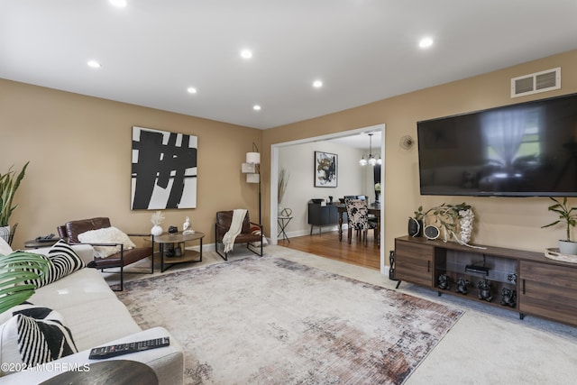 living room with wood-type flooring and an inviting chandelier