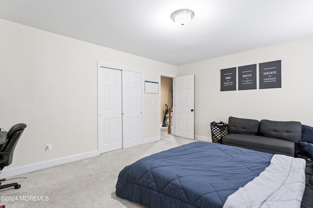 bedroom with light carpet and a closet