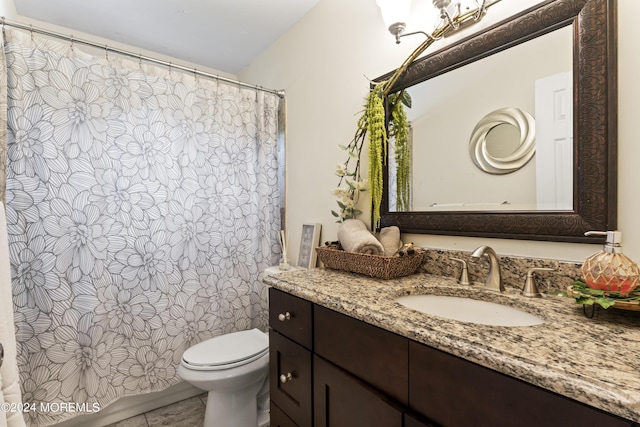 bathroom featuring tile patterned floors, vanity, and toilet