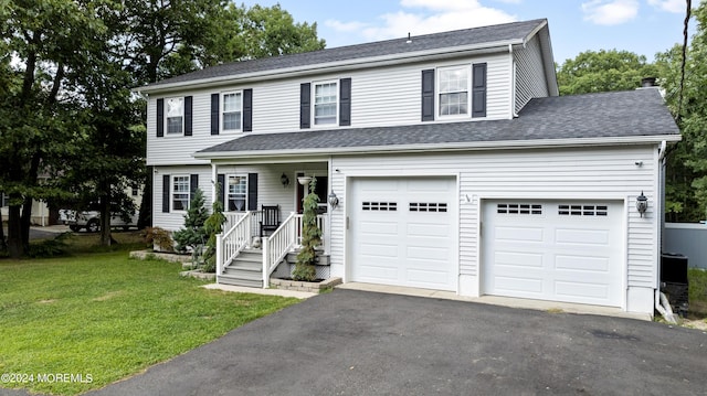 view of front facade with a front yard and a garage