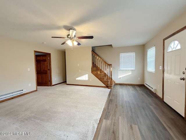 foyer entrance with ceiling fan, dark wood-type flooring, and a baseboard heating unit