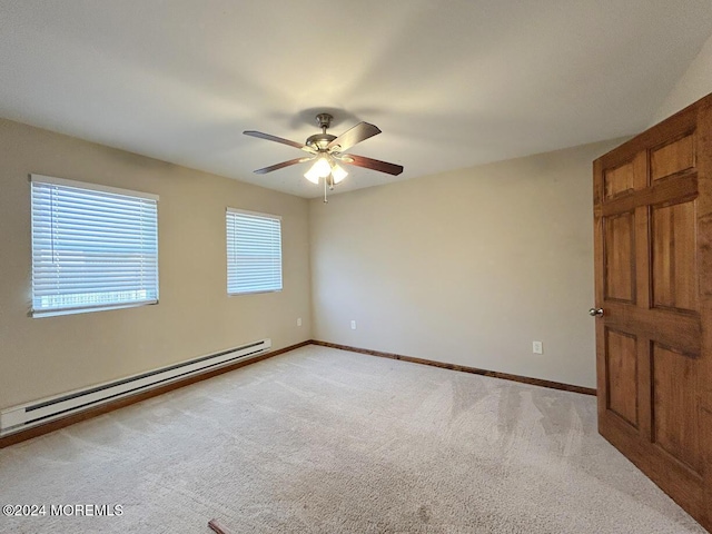 empty room featuring light carpet, ceiling fan, and a baseboard heating unit