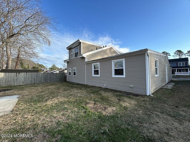 rear view of house featuring a lawn