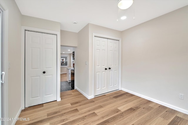 unfurnished bedroom featuring light wood-type flooring