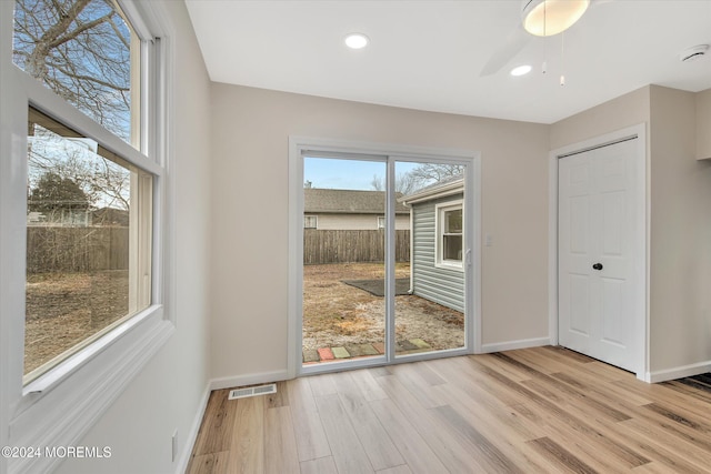 entryway with ceiling fan and light hardwood / wood-style flooring